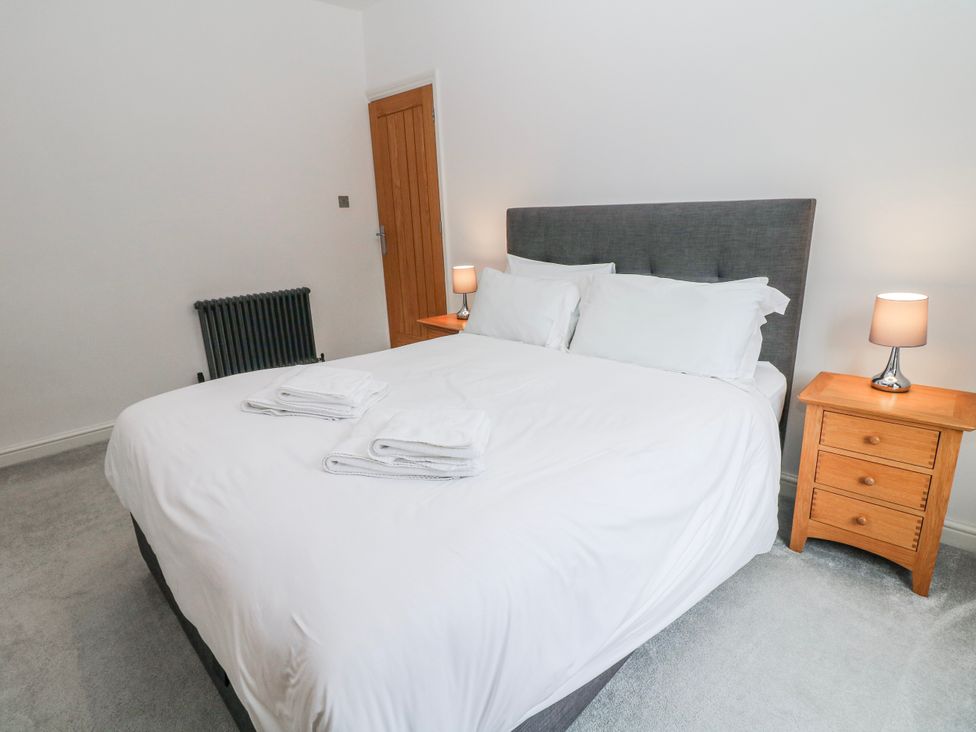 A bedroom with a bed and nightstand at Abraham in Matlock