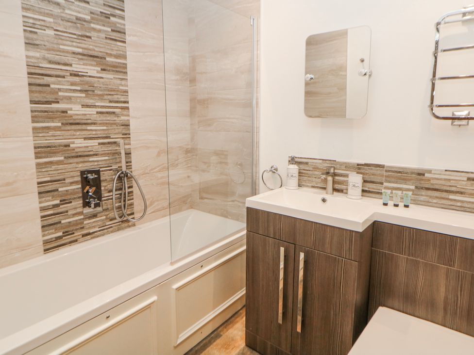 A bathroom with a bathtub and sink at Abraham in Matlock