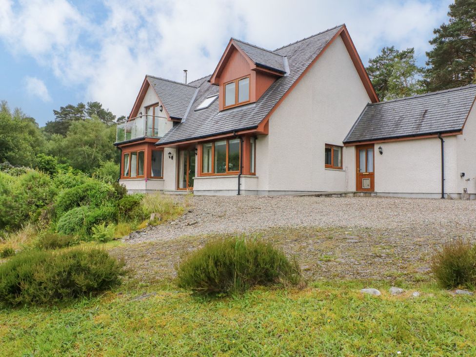 A house with a balcony and driveway at Thistle Do Lochailort