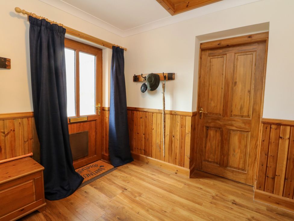 A hallway with a window and door at Thistle Do, Lochailort