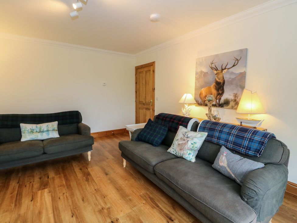 A living room with sofas and a painting at Thistle Do Lochailort