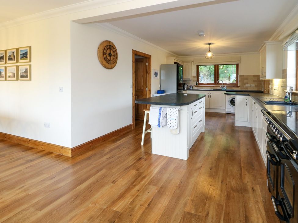 A kitchen with a countertop and refrigerator at Thistle Do Lochailort