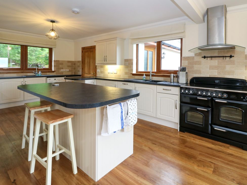 A kitchen with cabinets and an oven at Thistle Do in Lochailort