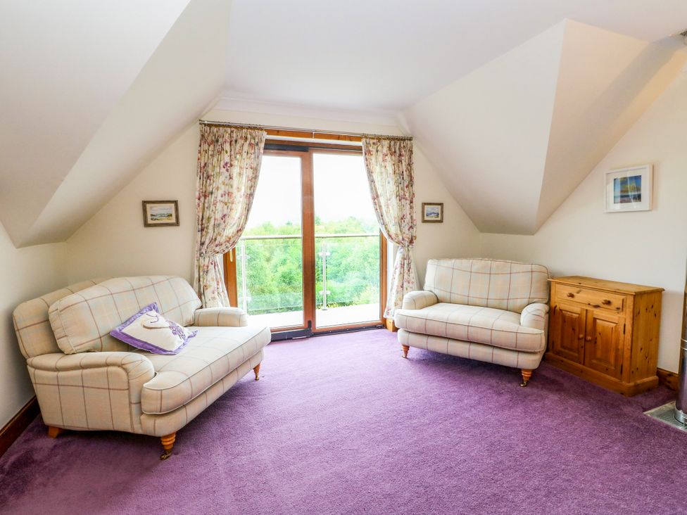 A living room with two sofas and a balcony at Thistle Do in Lochailort