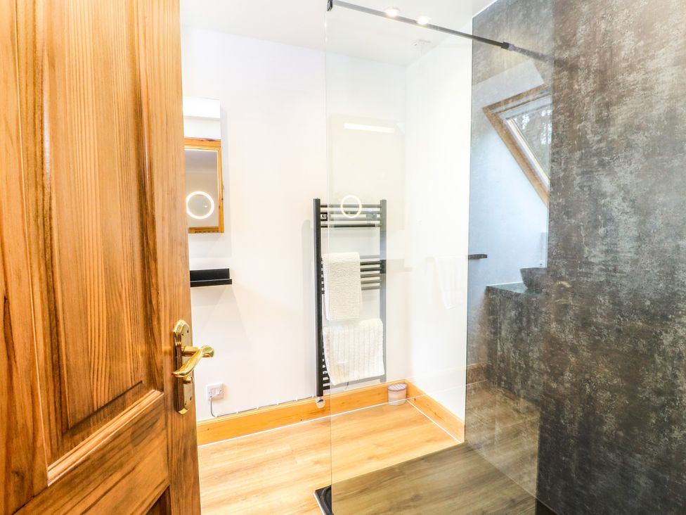 A bathroom with a shower and towel radiator at Thistle Do Lochailort