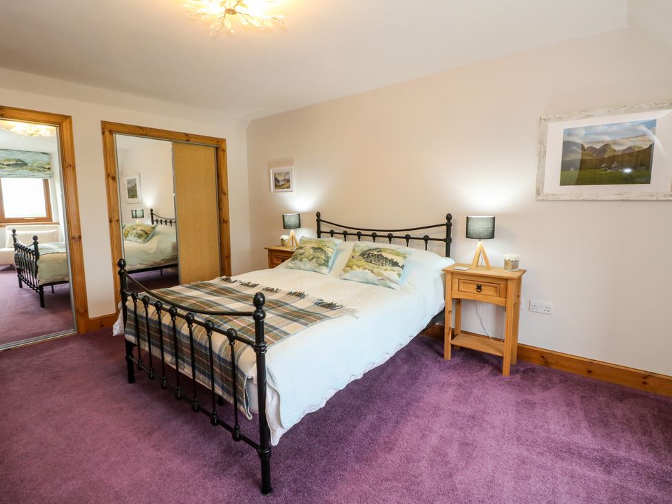 A bedroom with a bed and nightstand at Thistle Do Lochailort
