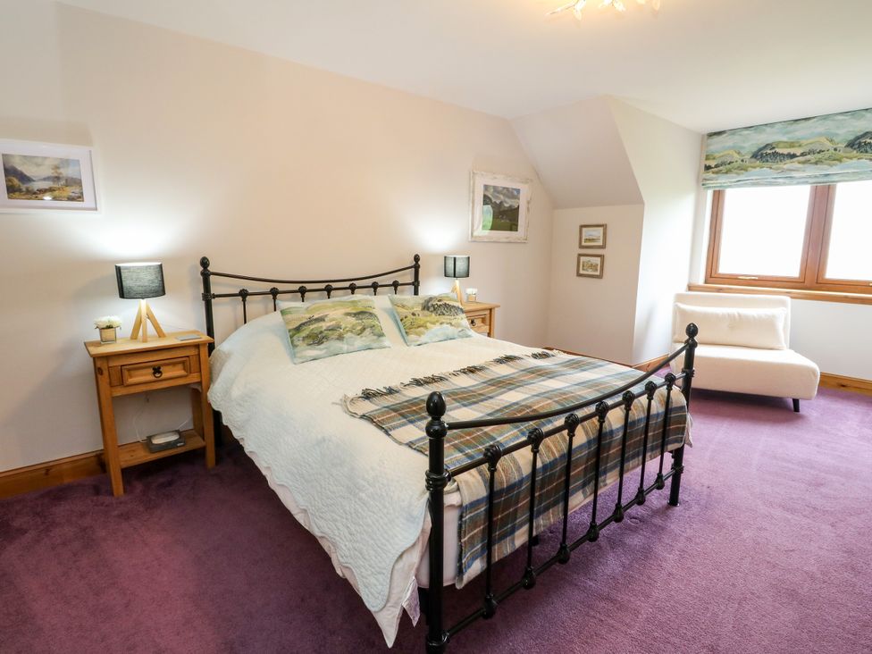 A bedroom with a bed and bedside tables at Thistle Do in Lochailort