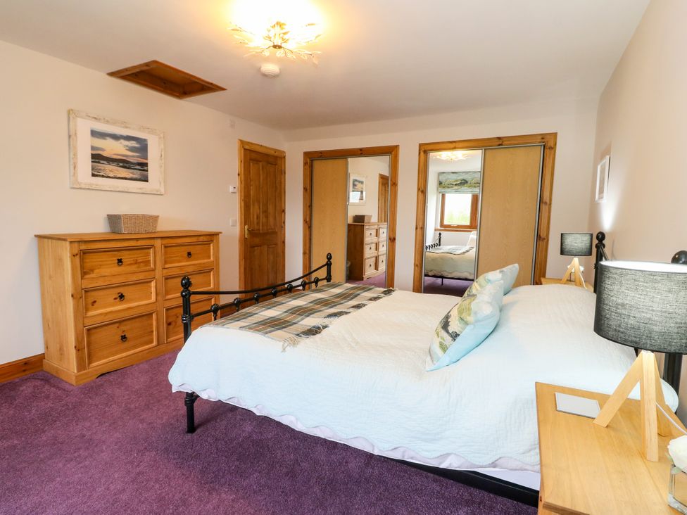 A bedroom with a bed and chest of drawers at Thistle Do Lochailort