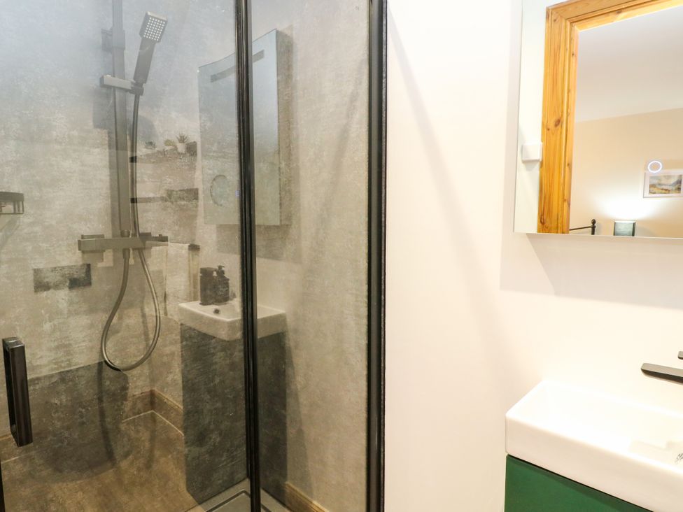 A bathroom with a shower and sink at Thistle Do in Lochailort