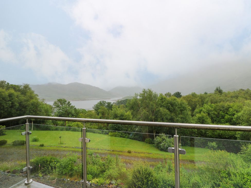 A balcony view overlooking water and mountains at Thistle Do Lochailort