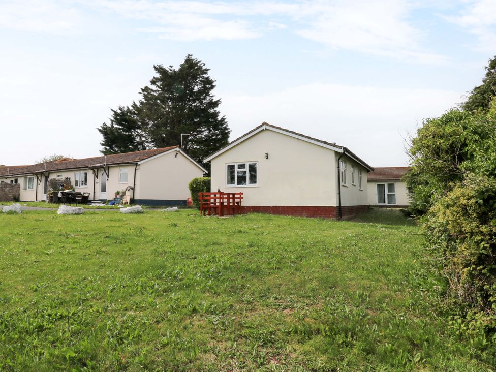 An outdoor view of houses and grass area at Cottage 28 in Brixham