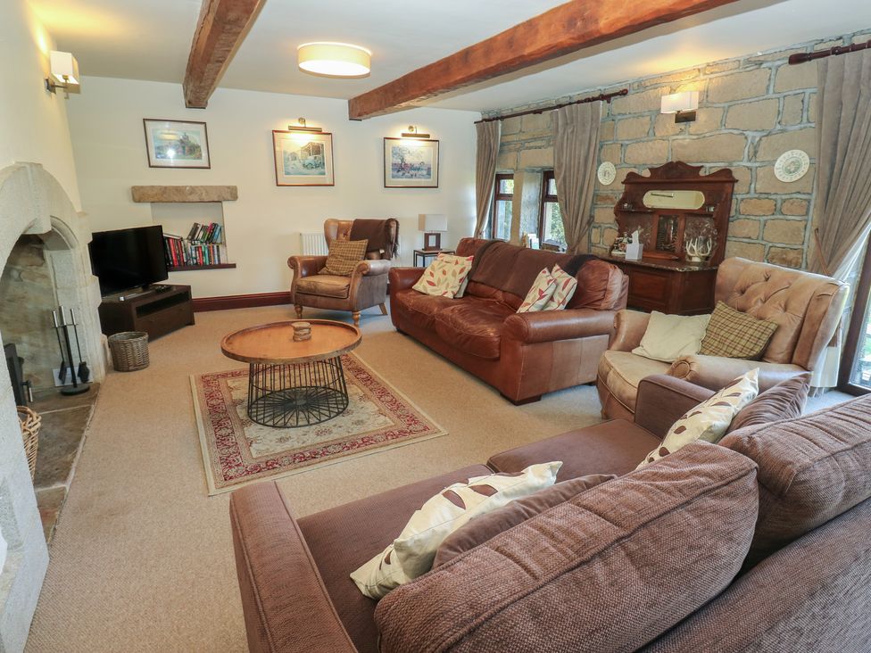 A living room with sofas and a coffee table at Shoebroad Barn in Todmorden