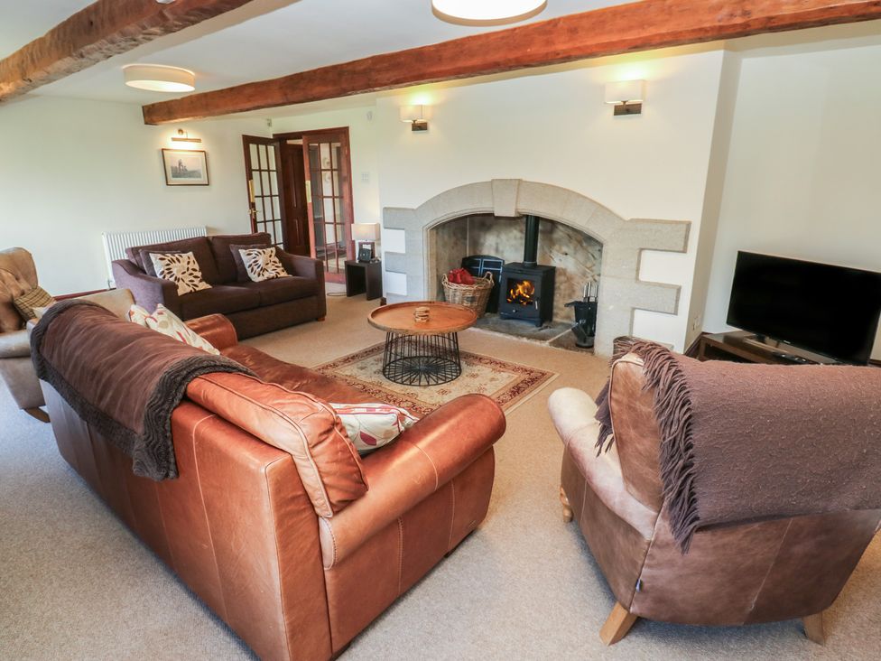 A living room with sofas and a fireplace at Shoebroad Barn Todmorden