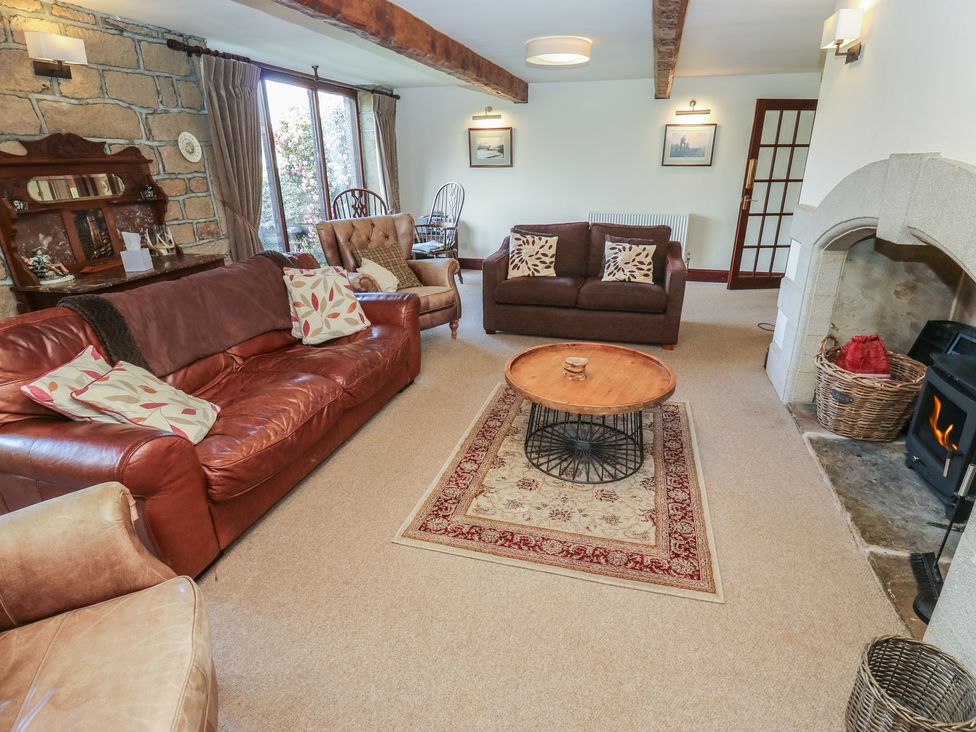 A living room with a sofa and coffee table at Shoebroad Barn Todmorden