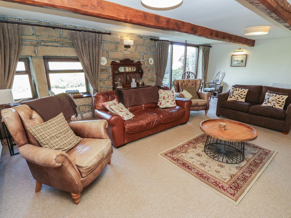A living room with sofas and a coffee table at Shoebroad Barn in Todmorden