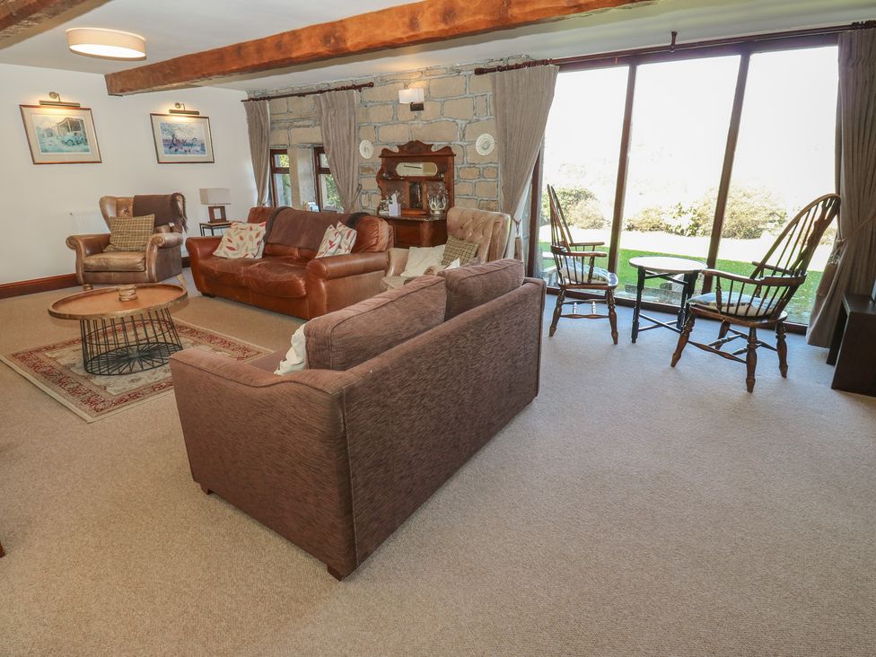A living room with a sofa and armchair at Shoebroad Barn in Todmorden