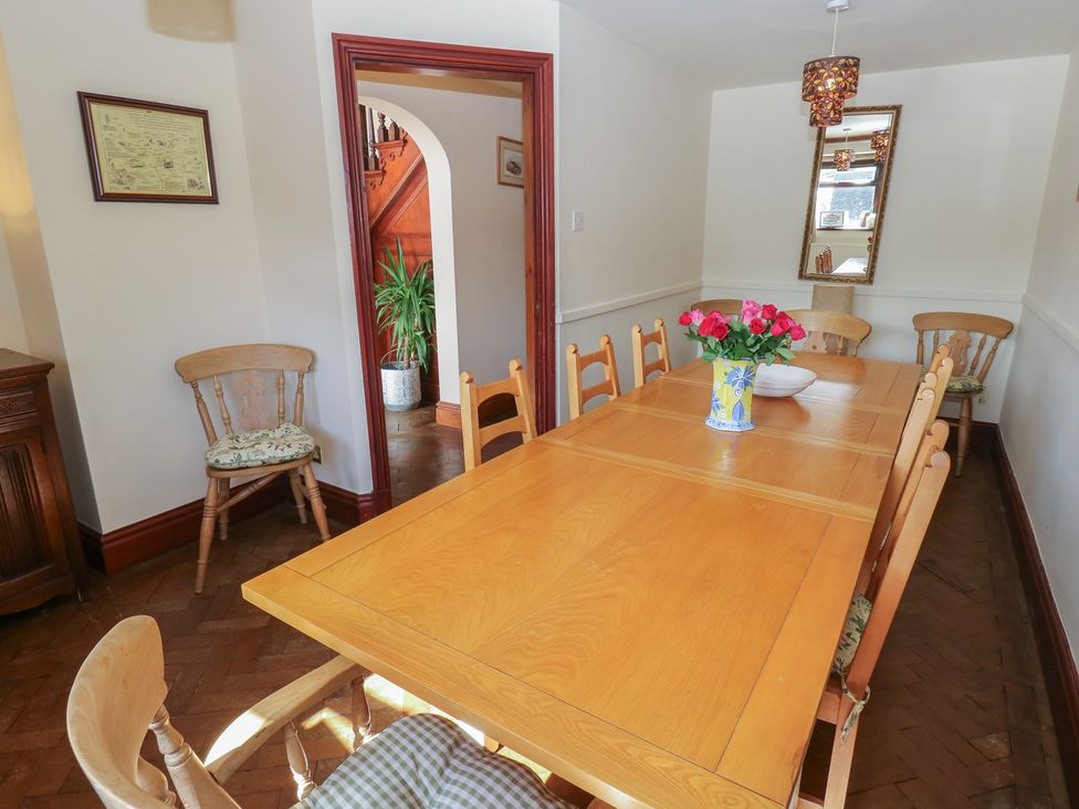 A dining room with a wooden table and chairs at Shoebroad Barn in Todmorden