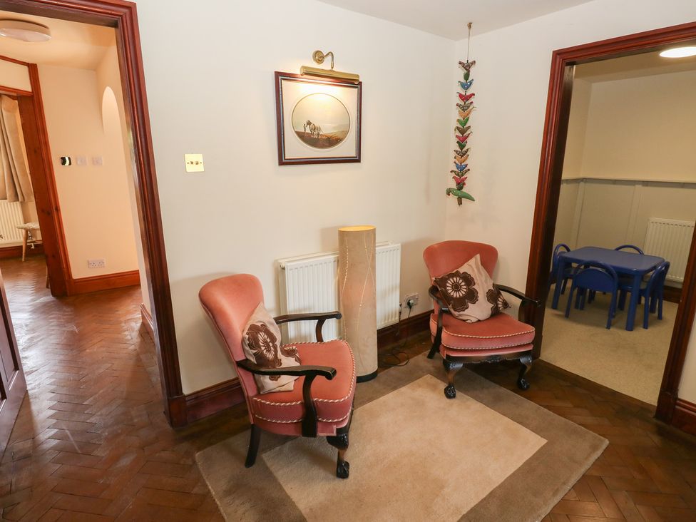A sitting room with two chairs and a lamp at Shoebroad Barn Todmorden