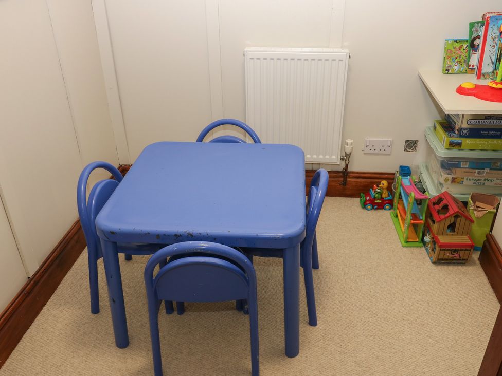 A playroom with a blue table and chairs at Shoebroad Barn in Todmorden