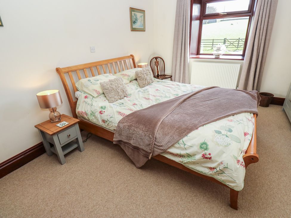 A bedroom with a bed and bedside table at Shoebroad Barn in Todmorden