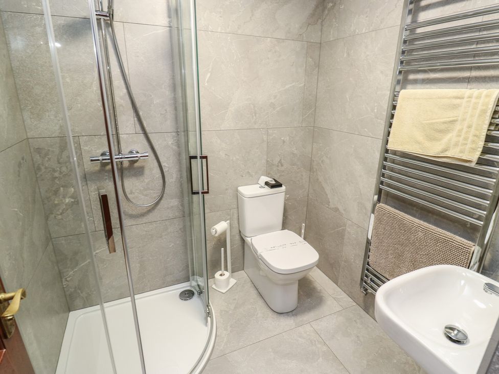 A bathroom with a shower, toilet, and sink at Shoebroad Barn Todmorden