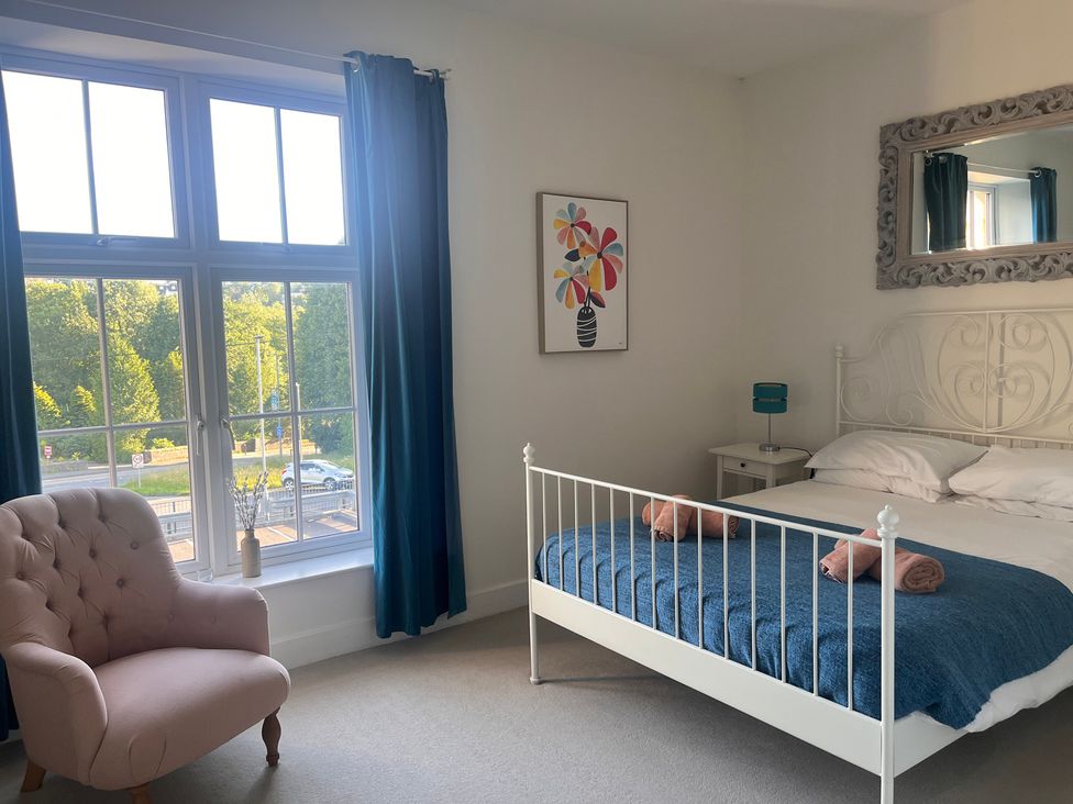 A bedroom with a bed and a chair at Cherrywood Manor in Bodmin