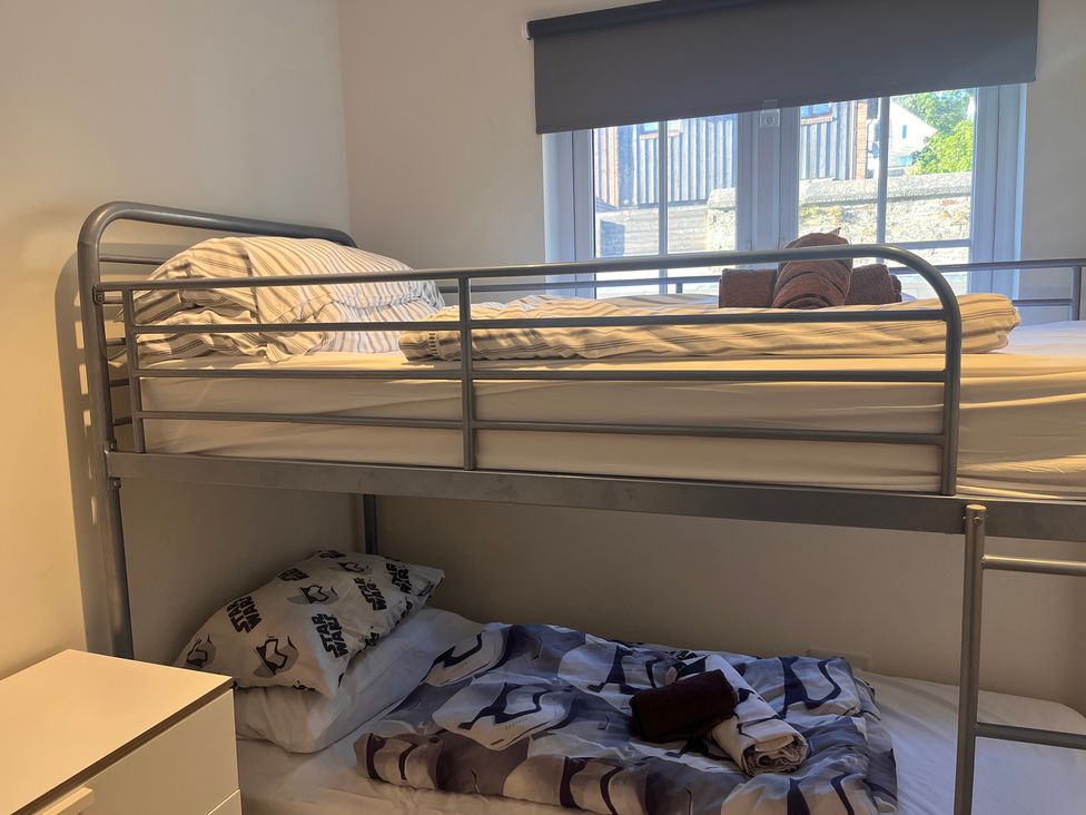 A bunk bed with bedding in a bedroom at Cherrywood Manor in Bodmin