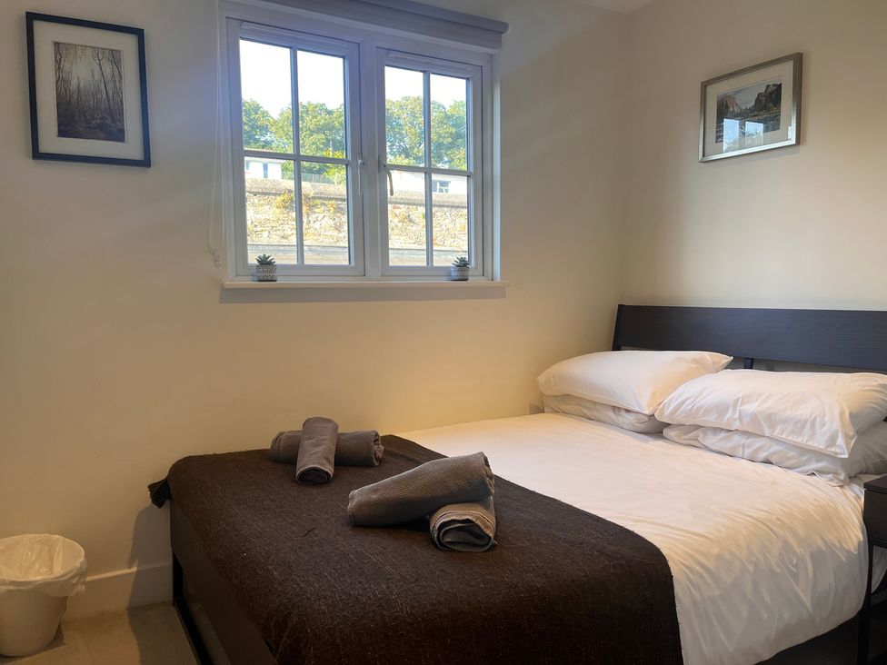 A bedroom with a bed and towels at Cherrywood Manor in Bodmin