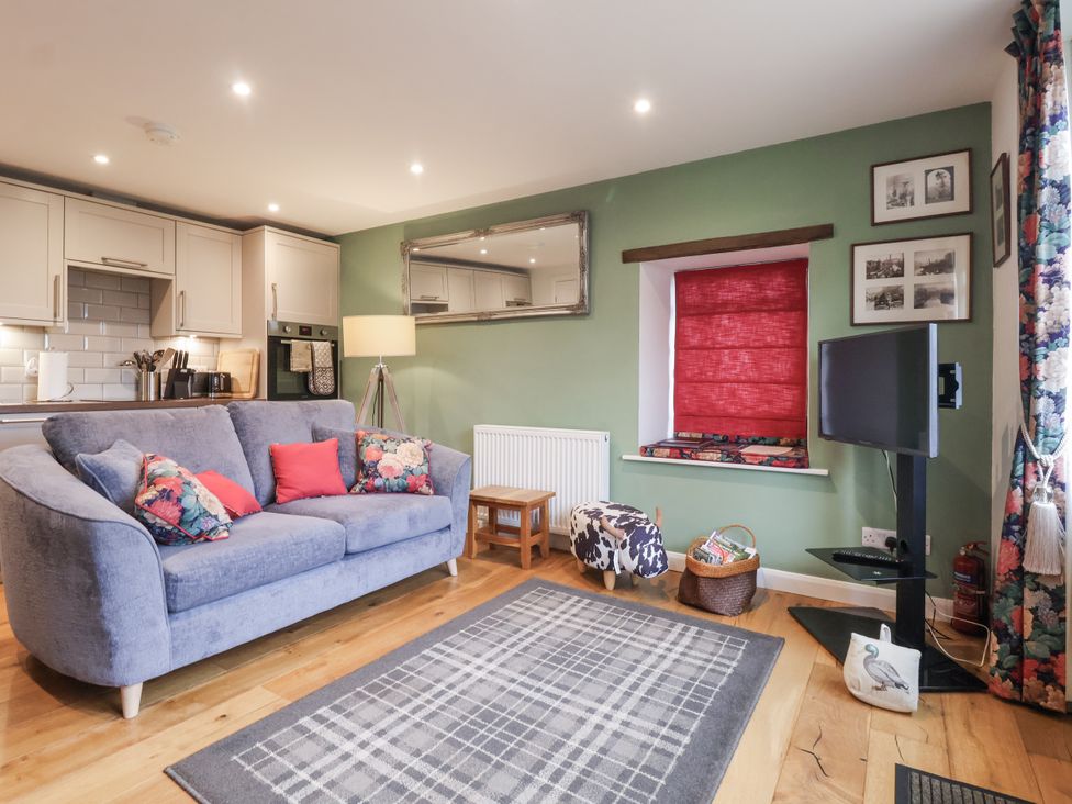 A living room with a sofa and television at The Farmhouse Kitchen in Ripon