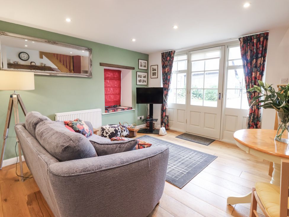 A living room with a sofa and television at The Farmhouse Kitchen in Ripon