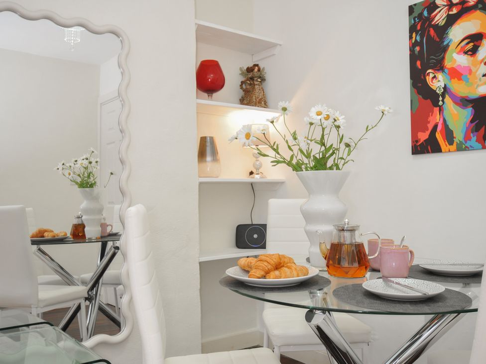 A dining room featuring a table set with tea and pastries at Stargazy, Trebarwith Strand near Tintagel