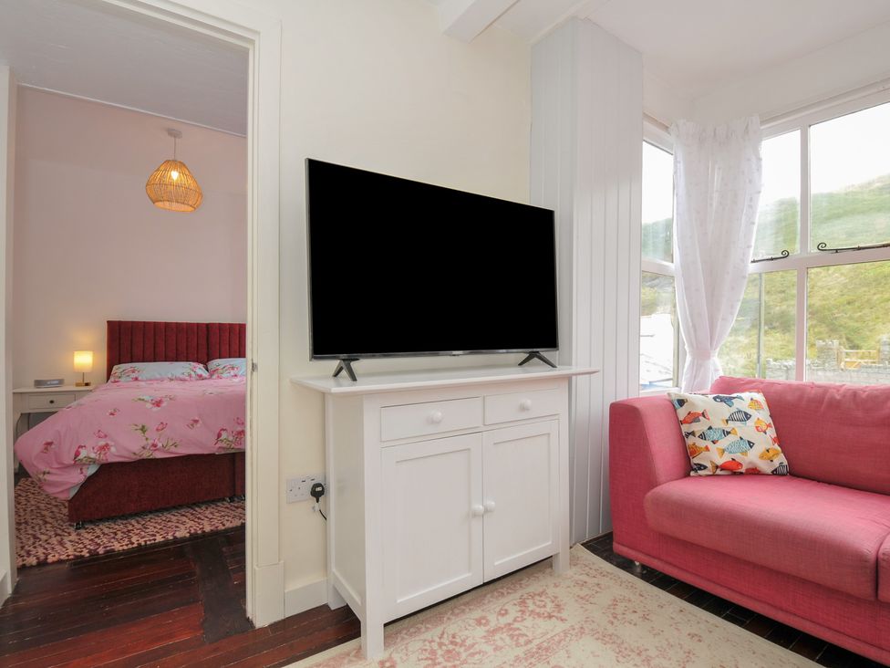 A living room with a television and sofa at Stargazy Trebarwith Strand near Tintagel