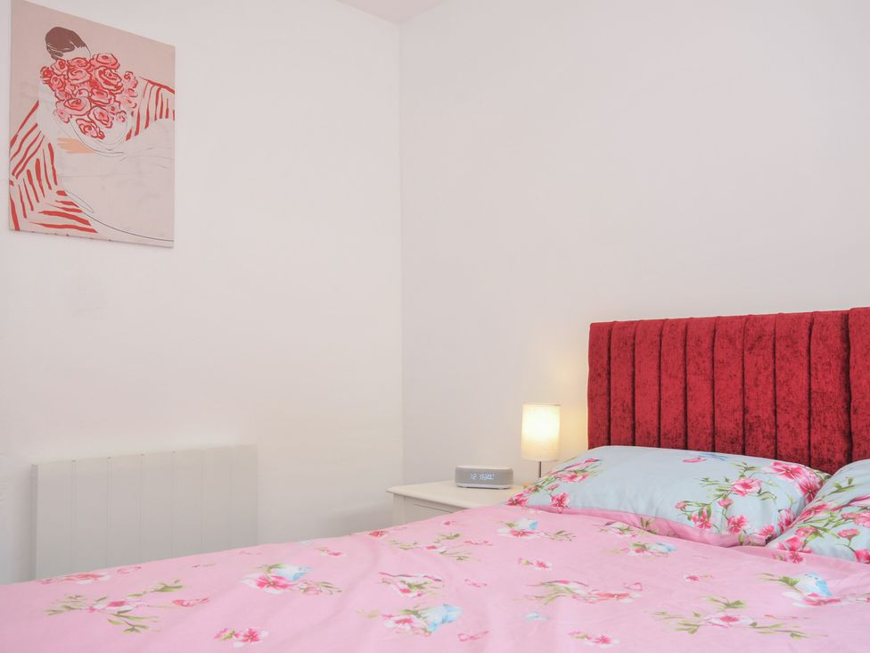A bedroom with a bed and bedside table at Stargazy in Trebarwith Strand near Tintagel