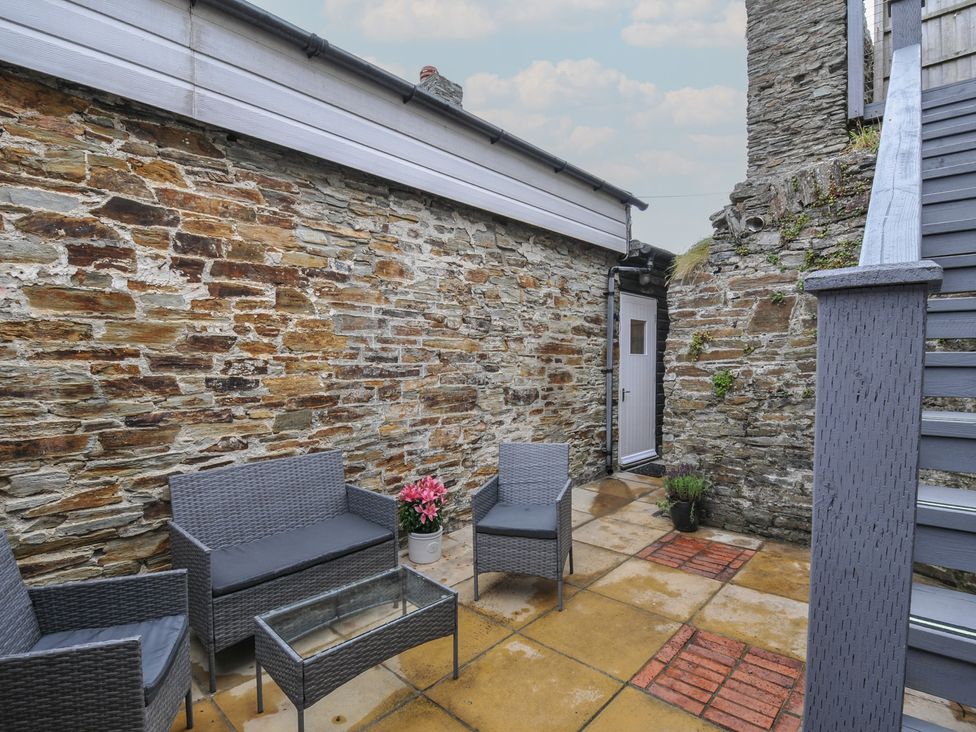 An outdoor patio with seating and plants at Stargazy in Trebarwith Strand near Tintagel