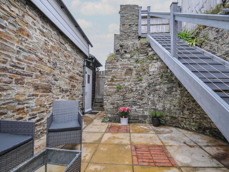 An outdoor space with a table and chairs at Stargazy Trebarwith Strand near Tintagel
