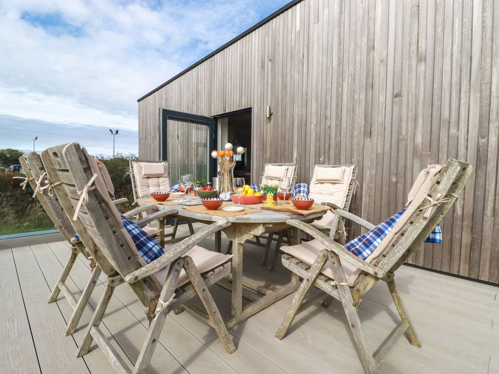 An outdoor dining area with a table and chairs at Idlewild, 2 Wheal Turnavore in St Agnes