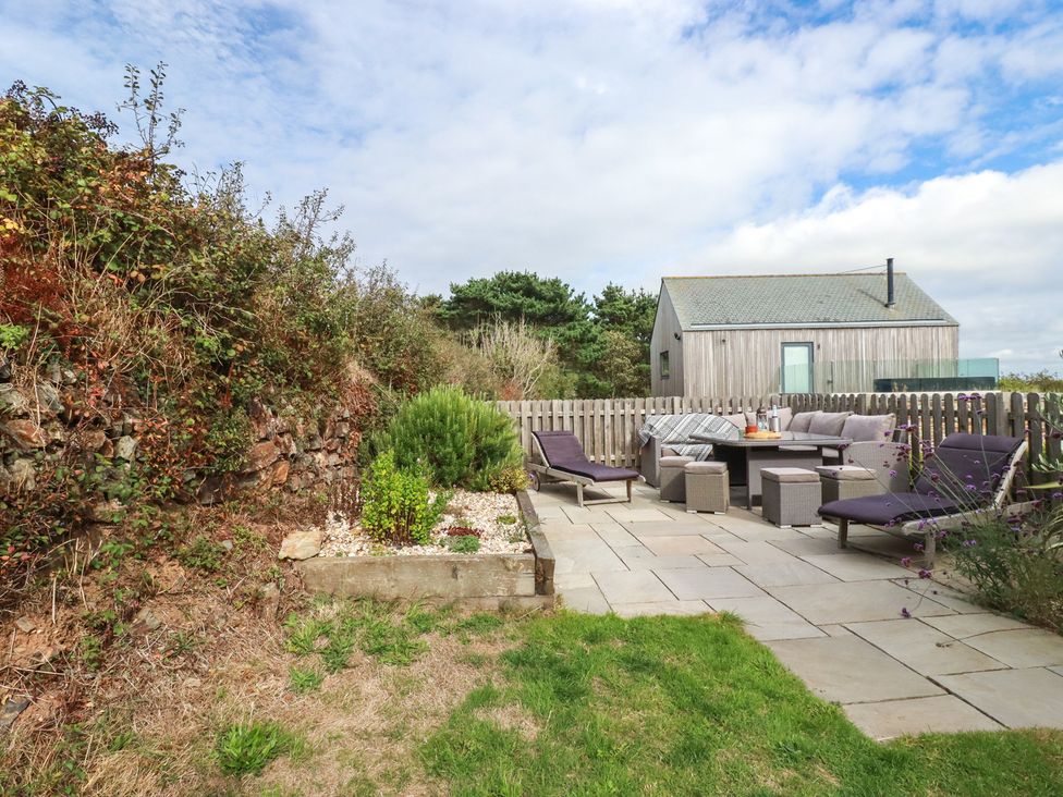 A garden with patio furniture and a wooden house at Idlewild, 2 Wheal Turnavore St Agnes