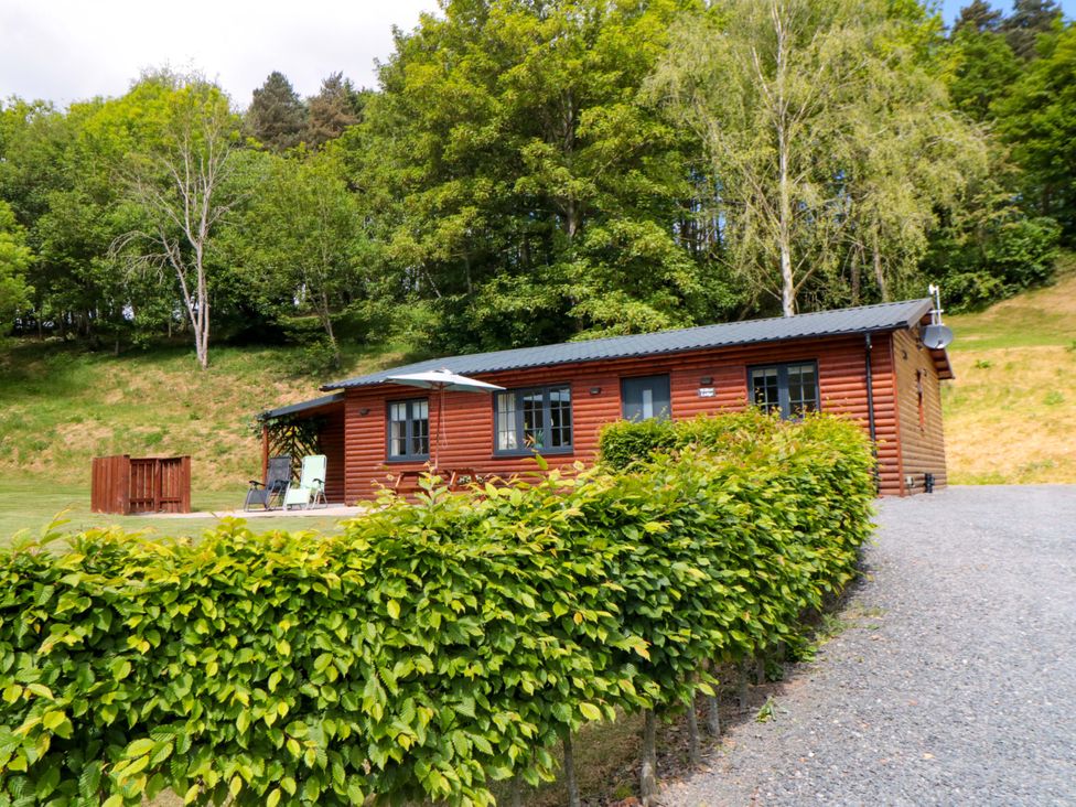 A log cabin with outdoor seating at Ryedale Country Lodges - Willow Lodge in Kirkbymoorside