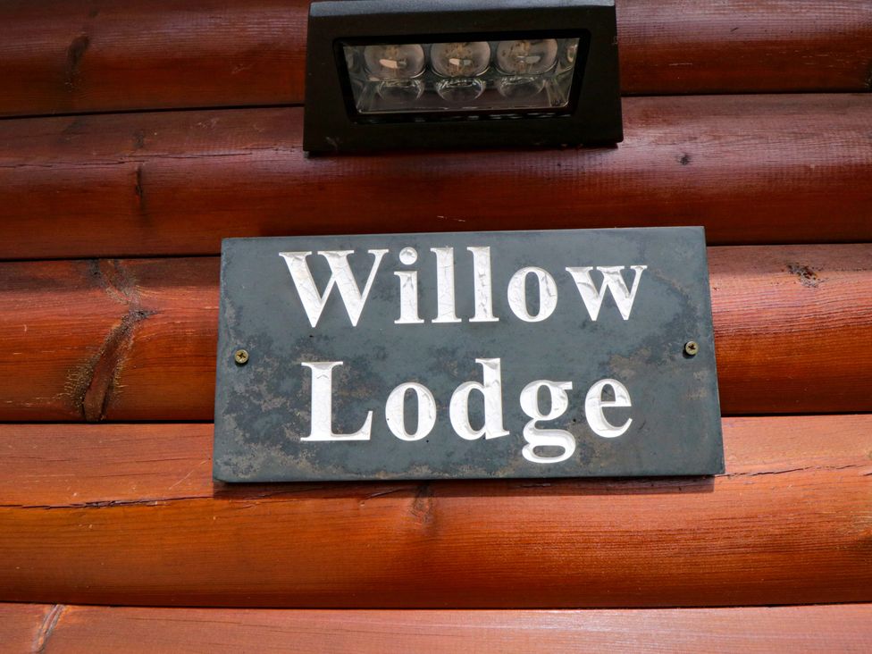 A sign that reads Willow Lodge at Ryedale Country Lodges - Willow Lodge Kirkbymoorside