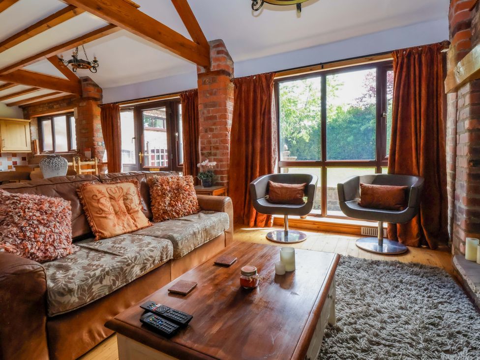 A living room with a sofa and coffee table at The Stables (2 bed) in Driffield