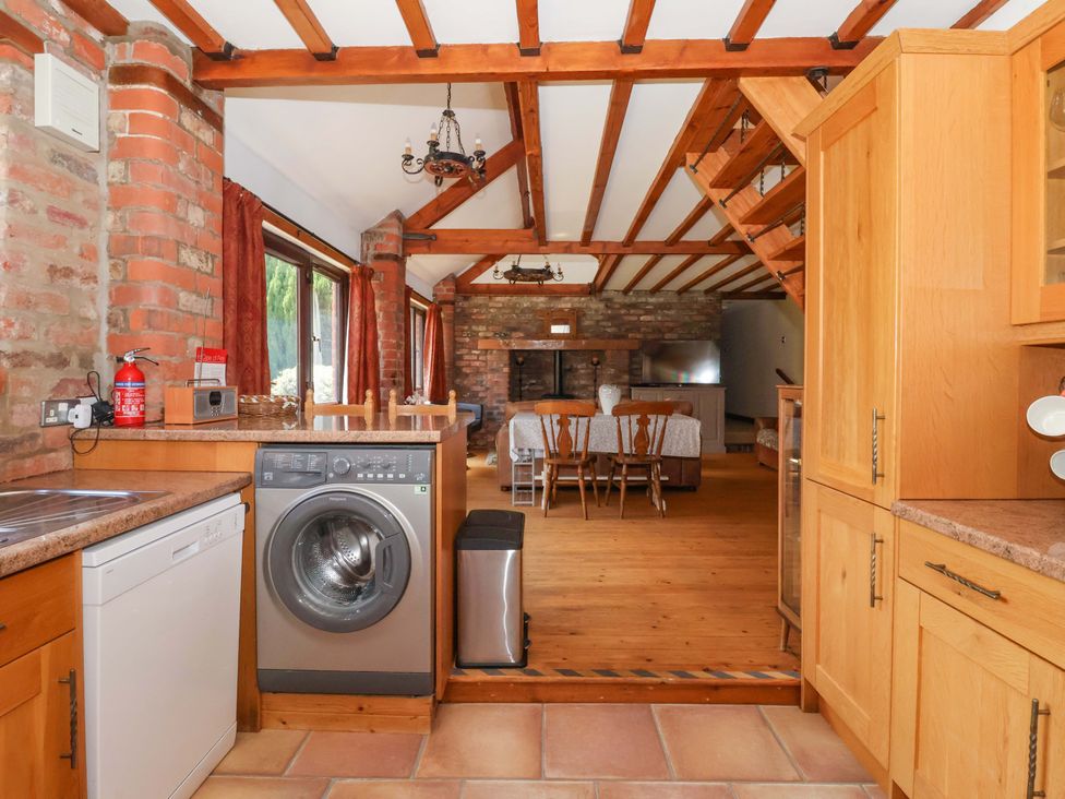 A kitchen with appliances and dining area at The Stables (2 bed) in Driffield