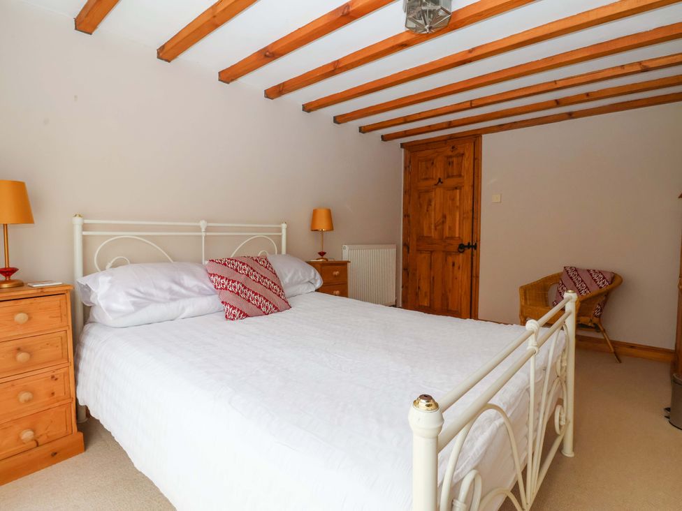 A bedroom with a bed and furniture at The Stables (2 bed) Driffield