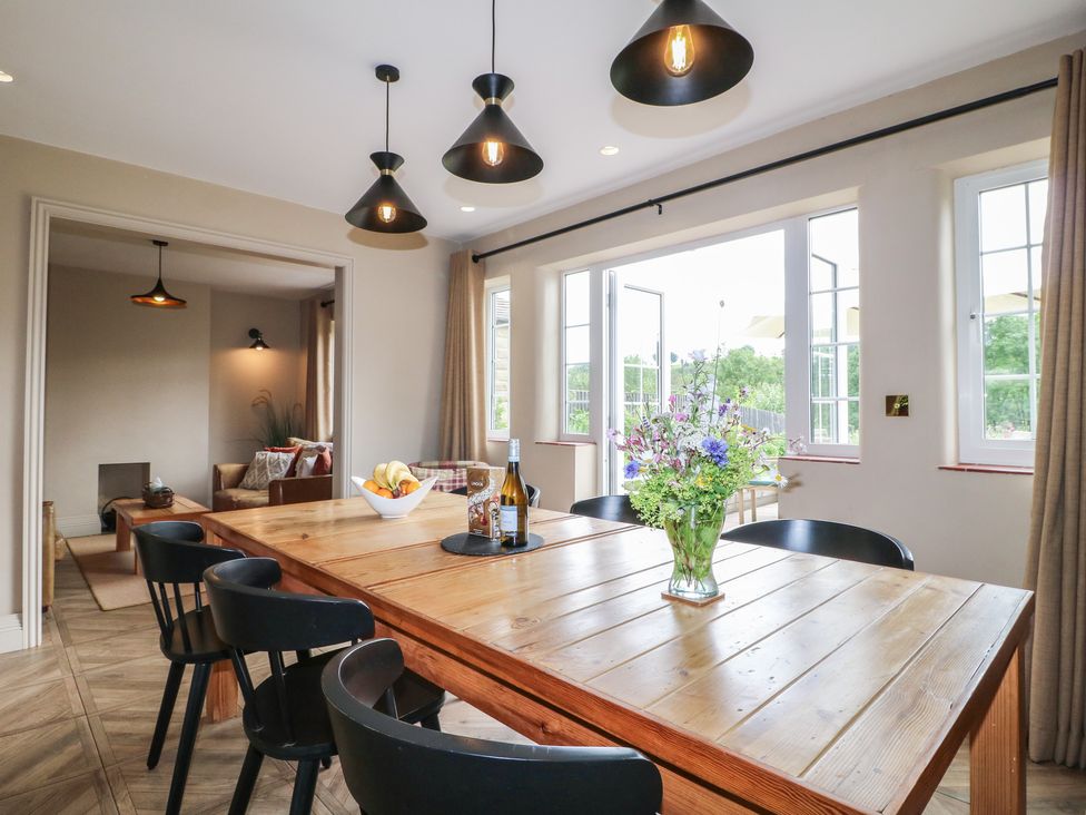 A dining room with a table and chairs at Ivet Lowe in Hopton near Wirksworth