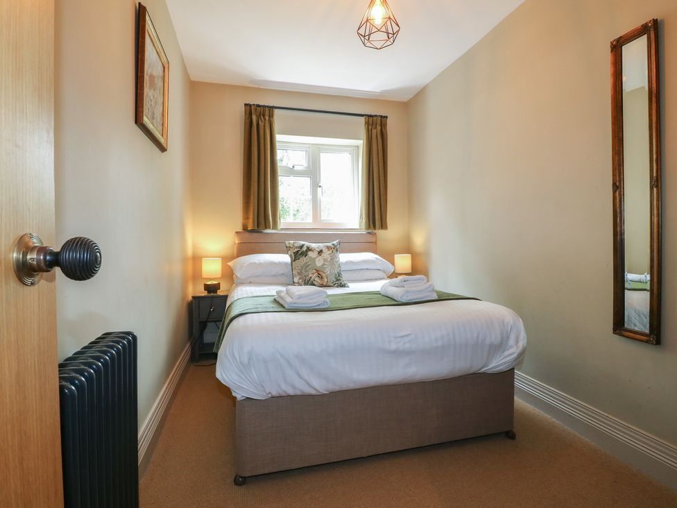 A bedroom with a bed and a window at Ivet Lowe in Hopton near Wirksworth