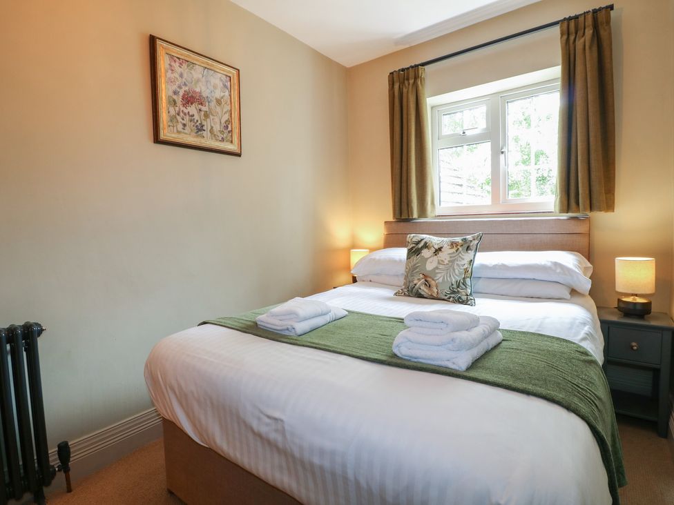 A bedroom with a double bed and bedside table at Ivet Lowe Hopton near Wirksworth