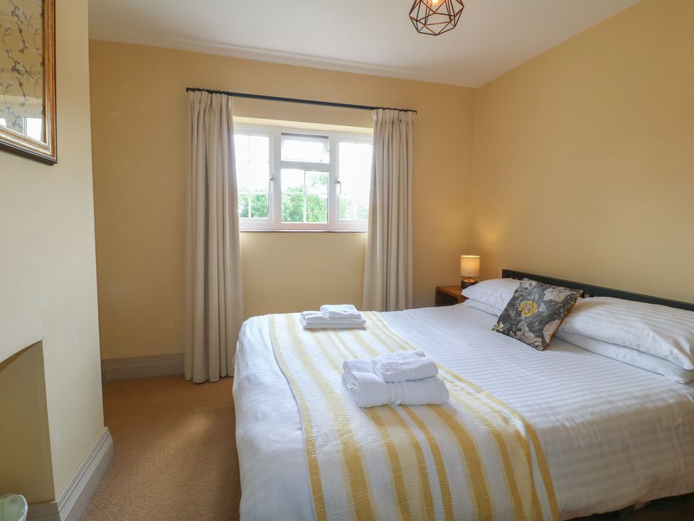 A bedroom with a bed and window at Ivet Lowe Hopton near Wirksworth