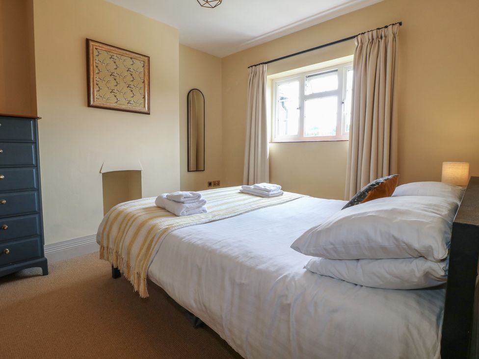 A bedroom with a bed and bedside table at Ivet Lowe in Hopton near Wirksworth