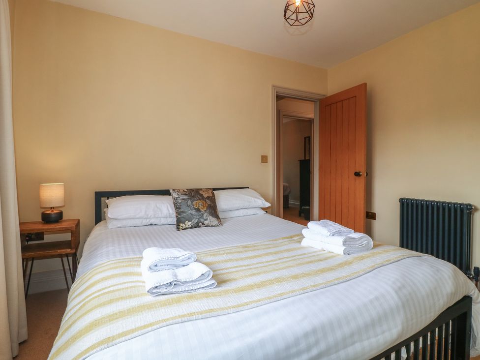 A bedroom with a bed and lamp at Ivet Lowe Hopton near Wirksworth