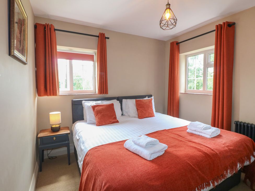 A bedroom with a double bed and bedside table at Ivet Lowe in Hopton near Wirksworth