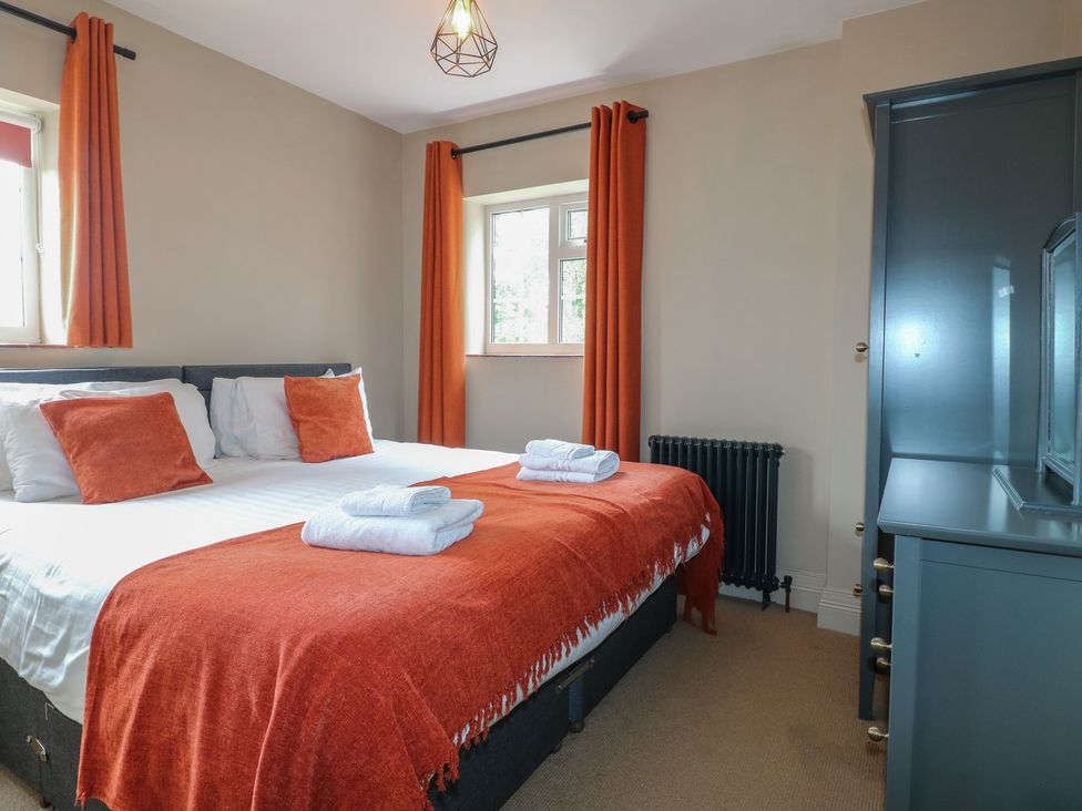 A bedroom with a double bed and dresser at Ivet Lowe in Hopton near Wirksworth